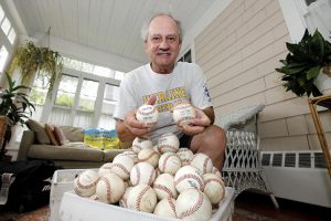 Basil Tarasko, pictured at his home, with balls donated for the Little League tournaments for orphanages in the Ukraine